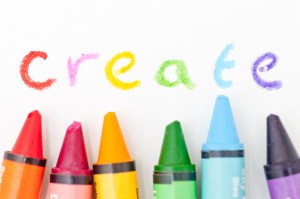 the word create written with multicolored crayons